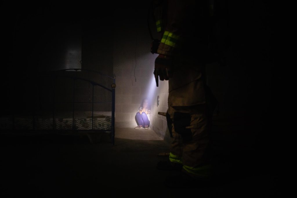 Firefighter shines a Foxfury BTS at a young lost girl in structure fire.
