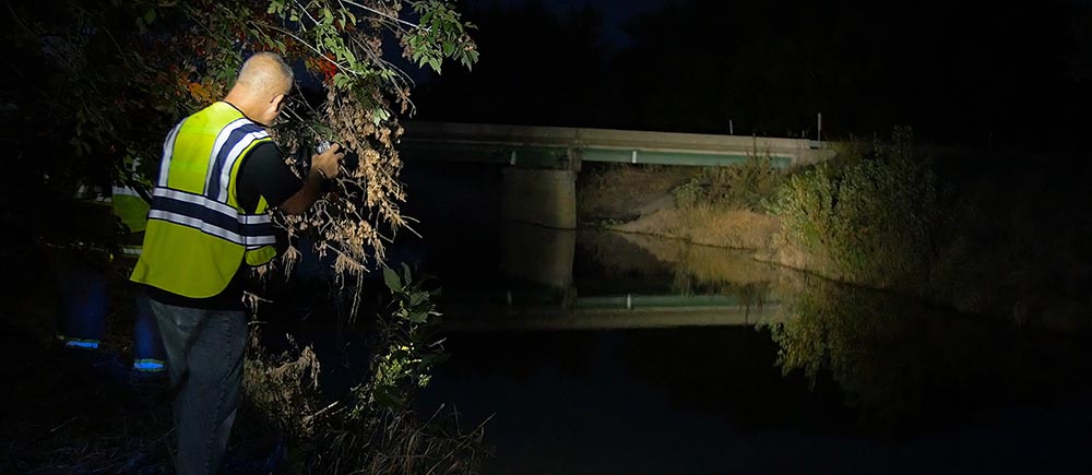 Search and rescue responder searches a river with a FoxFury BT2+ 90 dreee light